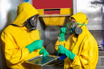 Man and woman in protective suits cooking meth in the lab