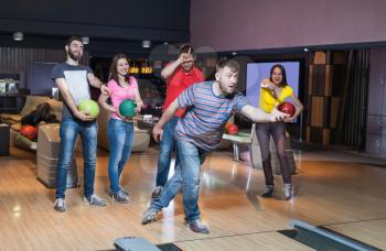 Friends having fun playing bowling