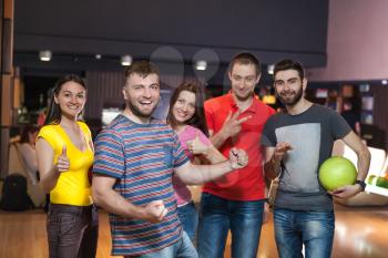 Friends having fun playing bowling