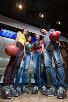 Bottom view of friends having fun in bowling
