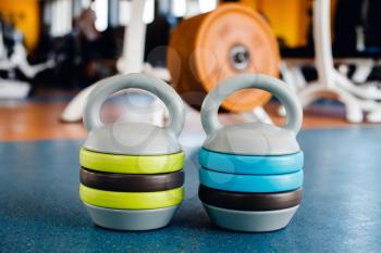 Kettle bells with weight plates on the floor in the gym