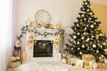 Christmas decorated house interior with fireplace, wall clock, xmas tree and presents under it. Merry xmas and new year concept. 