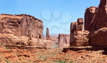 Mountains in valley against blue sky background. Landscape of Arches National Park