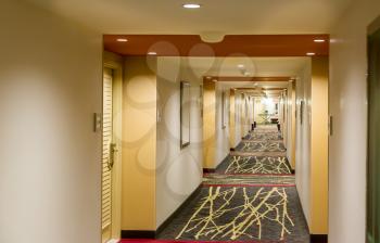 Hotel corridor interior with carpet. Empty hotel hallway.
