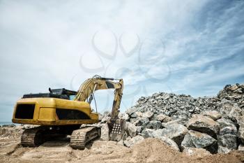 Shovel mashine work with sand and stones. Yellow earthmover