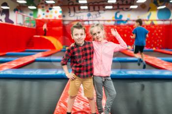 Kids leisure, children play on inflatable attractions in game entertainment center. Happy childhood. Adventure time