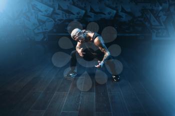 Male rapper in dance studio, trendy lifestyle. Modern urban dancing style