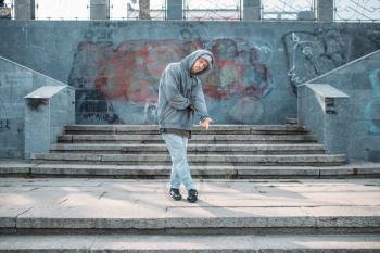 Male rapper posing on the street, urban dancing. Modern dance style