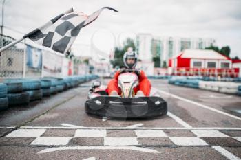 Carting racer on start line, front view, go cart driver