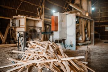 Stack of boards near woodworking machine in sawdust, nobody, lumber industry, carpentry. Wood processing on factory, forest sawing in lumberyard, sawmill