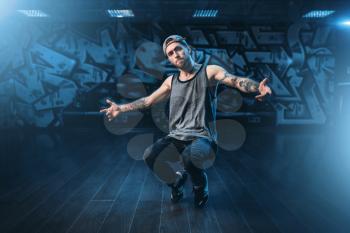 Male rapper in dance studio, trendy lifestyle. Modern urban dancing style