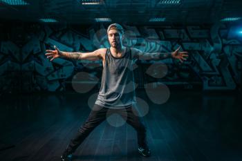 Male rapper in dance studio, trendy lifestyle. Modern urban dancing style