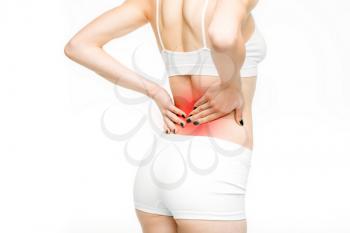 Back pain, woman with backache on white background. Female person in white lingerie, medical advertising or concept