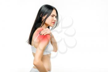 Joint pain, woman have problem with shoulder, white background. Female person in white lingerie, medical advertising or concept