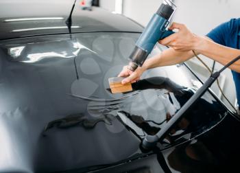 Male specialist with drier, car tinting film installation process, tinted auto glass installing procedure