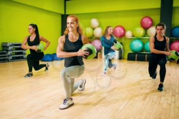 Women group with balls in motion, fitness workout. Female sport teamwork in gym. Fit exercise, aerobic