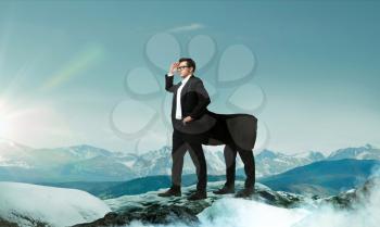 Success business way concept. Purposeful and confident businessman centaur looking forward on the top of mountain