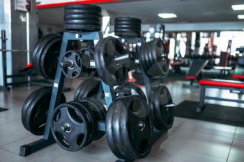 Weights for a bar, sport equipment in gym, fitness club interior, bodybuilding concept
