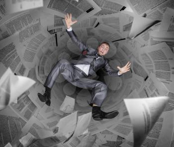 Crazy businessman drowning in a pile of papers and reports, bureaucracy and routine in business