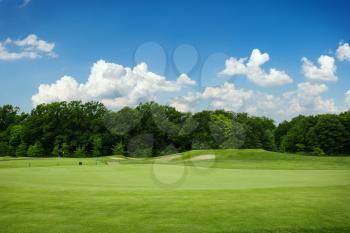 Trimmed lawn and sand bunkers for golfing on golf course, nobody. Meadow in sport club, playground with green grass