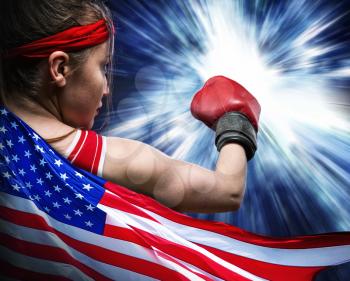 Female boxer in red gloves and sportswear against USA flag. Woman on boxing workout, american fighter