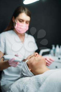 Getting rid of wrinkles in cosmetology clinic. Facial skincare in spa salon, health care. Rejuvenation procedure, beauty medicine