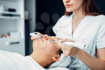 Face rejuvenation procedure to woman, beauty medicine, cosmetology clinic. Facial skincare in spa salon