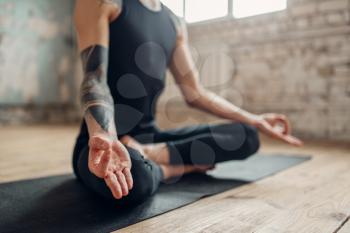 Male yoga, meditation in asana position, full relaxation. Fit workout indoors, yogi studio