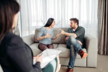Couple sitting on sofa, psychologist reception, civilized solution to the problem. Female doctor helps patients with consultation, family psychology support