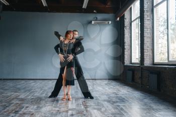 Dancers on ballrom dance training in class. Female and male partners on professional pair dancing in studio