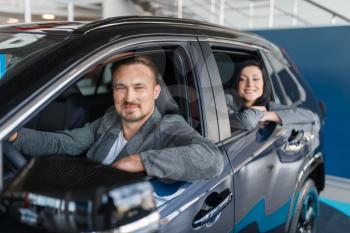 Happy couple buying new car in showroom, departure from the salon. Male and female customers choosing vehicle in dealership, automobile sale, auto purchase