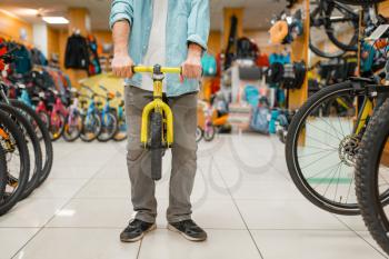 Male person with children's bicycle, shopping in sports shop. Summer season extreme lifestyle, active leisure store, customer buying cycle for family riding