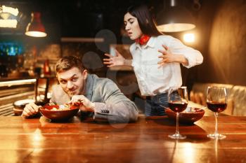 Couple at wooden bar counter, love relationship, dinner with paste and red wine. Lovers leisures in pub, husband and wife in nightclub