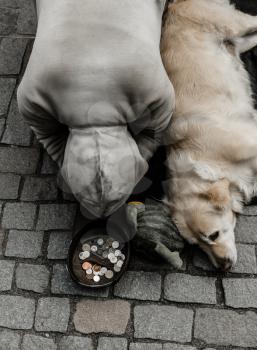 The beggar with dog begging for alms, European city. Summer tourism and travels, famous europe landmark, popular places and streets