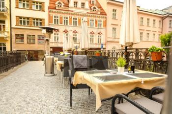 Cosy outdoor cafe with rattan furniture, Karlovy Vary, Czech Republic, Europe. Old european town, famous place for travel