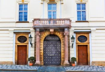 Ancient building facade with big doors, old European town. Summer tourism and travels, famous europe landmark, popular places and streets