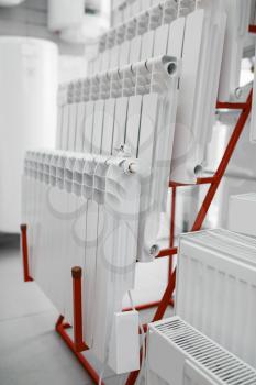 Water heating radiators choice on showcase in plumbering store. Sanitary engineering shop, nobody