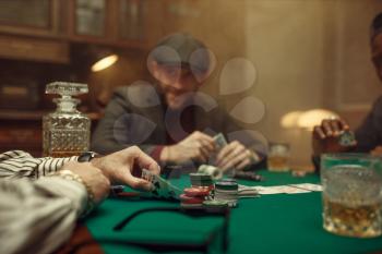 Professional poker player playing in casino. Games of chance addiction. Man with cards in hands leisures in gambling house