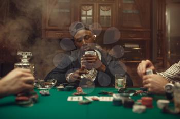 Poker players at gaming table with bets, casino. Games of chance addiction, risk, gambling house. Men leisures with whiskey and cigars