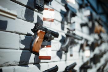 Handguns on showcase in gun shop closeup, nobody. Euqipment for security on stand in weapon store, selfdefence and sport shooting hobby