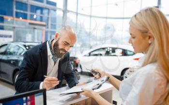 Man signs a contract to buy a new auto in car dealership. Customer and saleswoman in vehicle showroom, male person buying transport, automobile dealer business