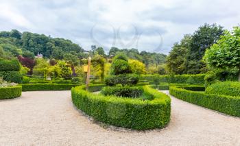 Figures from the bushes in different shapes, summer park in Europe. Professional gardening, european green landscape, garden plants decoration
