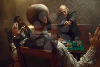 Poker player with gun wants to take the winnings, showdown with opponents in casino, risk. Games of chance addiction. Men with whiskey and cigars in gambling house