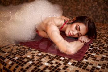Woman in foam, turkish bath, hamam. Skin and body care