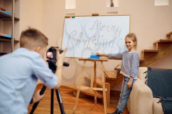Little boy and girl, bloggers makes christmas blog, little vloggers. Kids blogging in home studio, social media for young audience, online internet broadcast