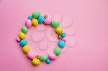 Colorful easter eggs on pink background, top view. Paschal food, event decoration, spring holiday celebration symbol