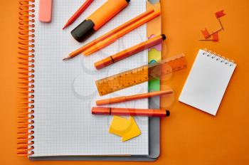 Office stationery supplies, opened notepad, top view, closeup. School or education accessories, writing and drawing tools