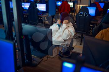 Young gamer staring at the monitor, game club. Virtual entertainment, e-sport tournament, cybersport lifestyle. Male person leisures in internet cafe