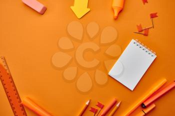 Office stationery supplies,macro view, orange background. School or education accessories