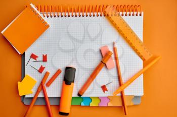 Office stationery supplies, opened notepad, top view, closeup. School or education accessories, writing and drawing tools